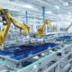 Video For Manufacturing Showing Large Robotic Arms In Factory